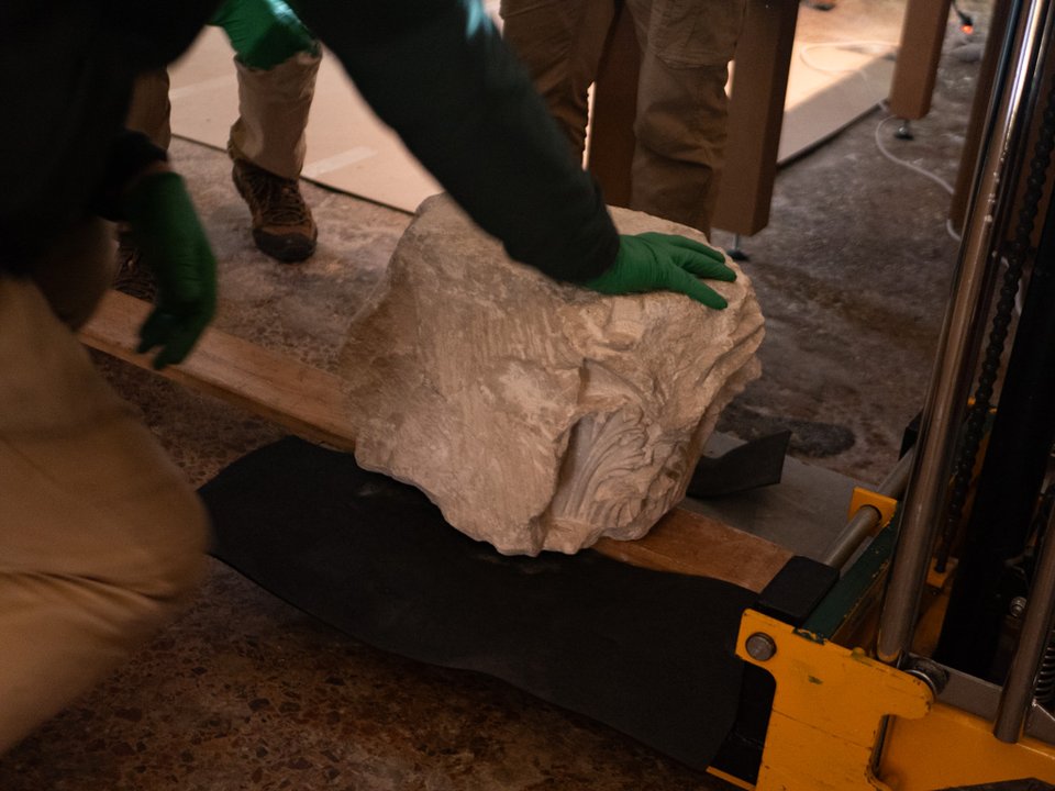 The museum crew installing the capital into the holographic device